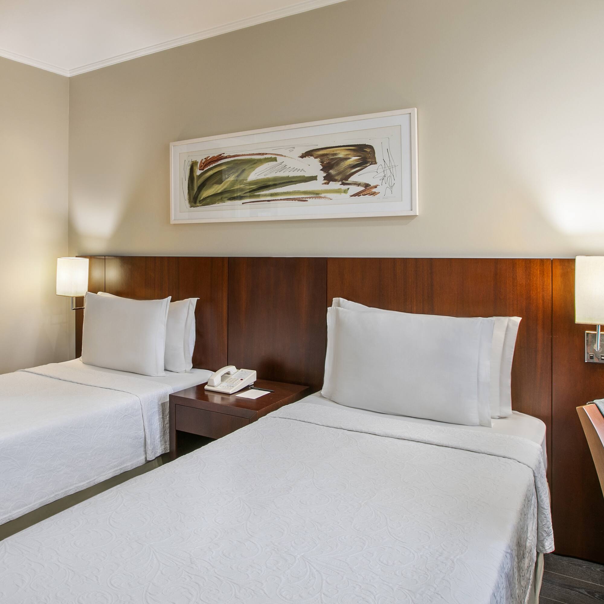 a room with two beds and a telephone