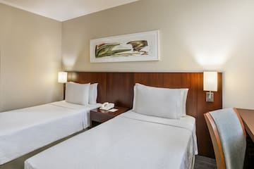 a room with two beds and a telephone