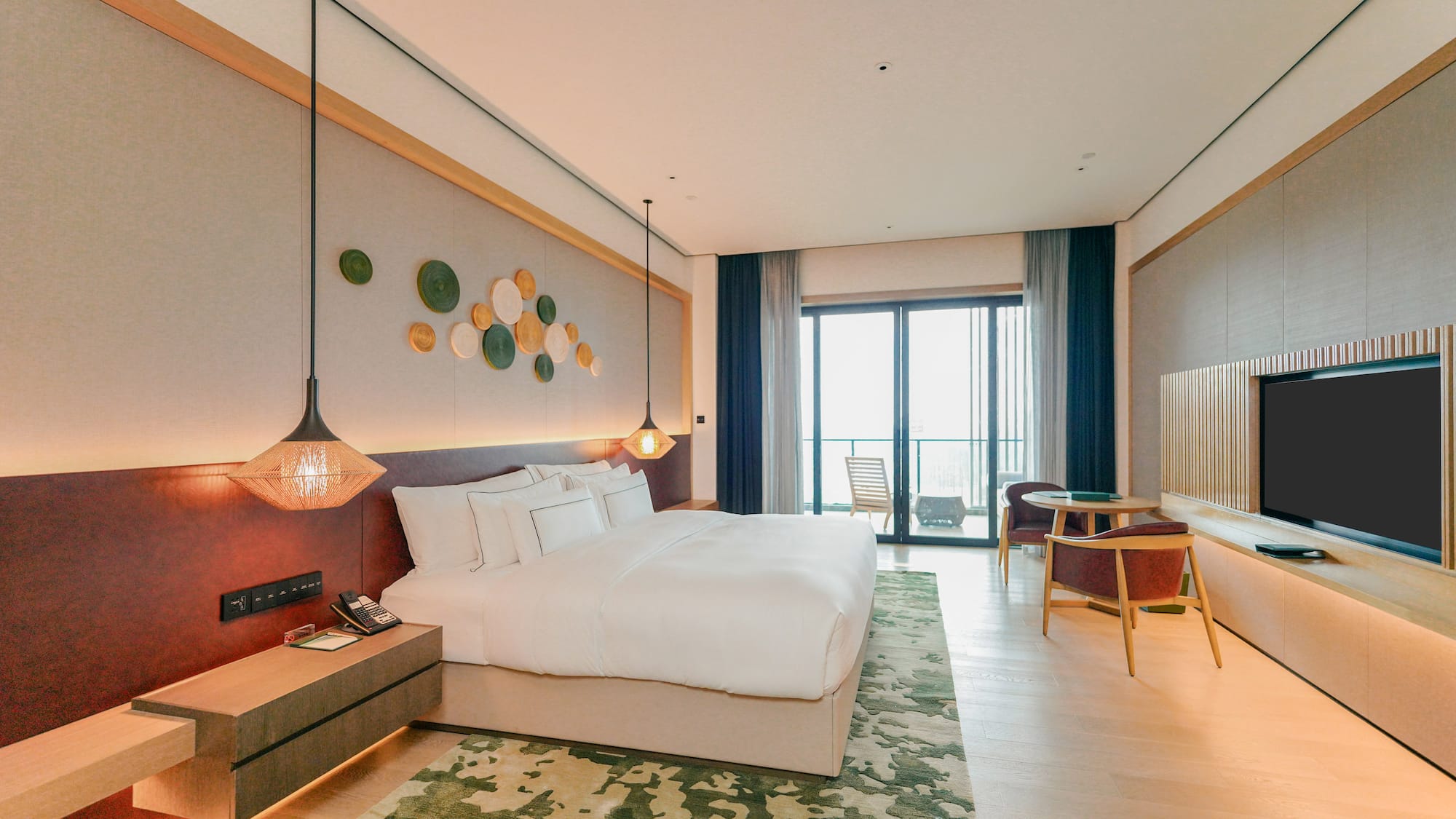 a room with a bed and a table and chairs