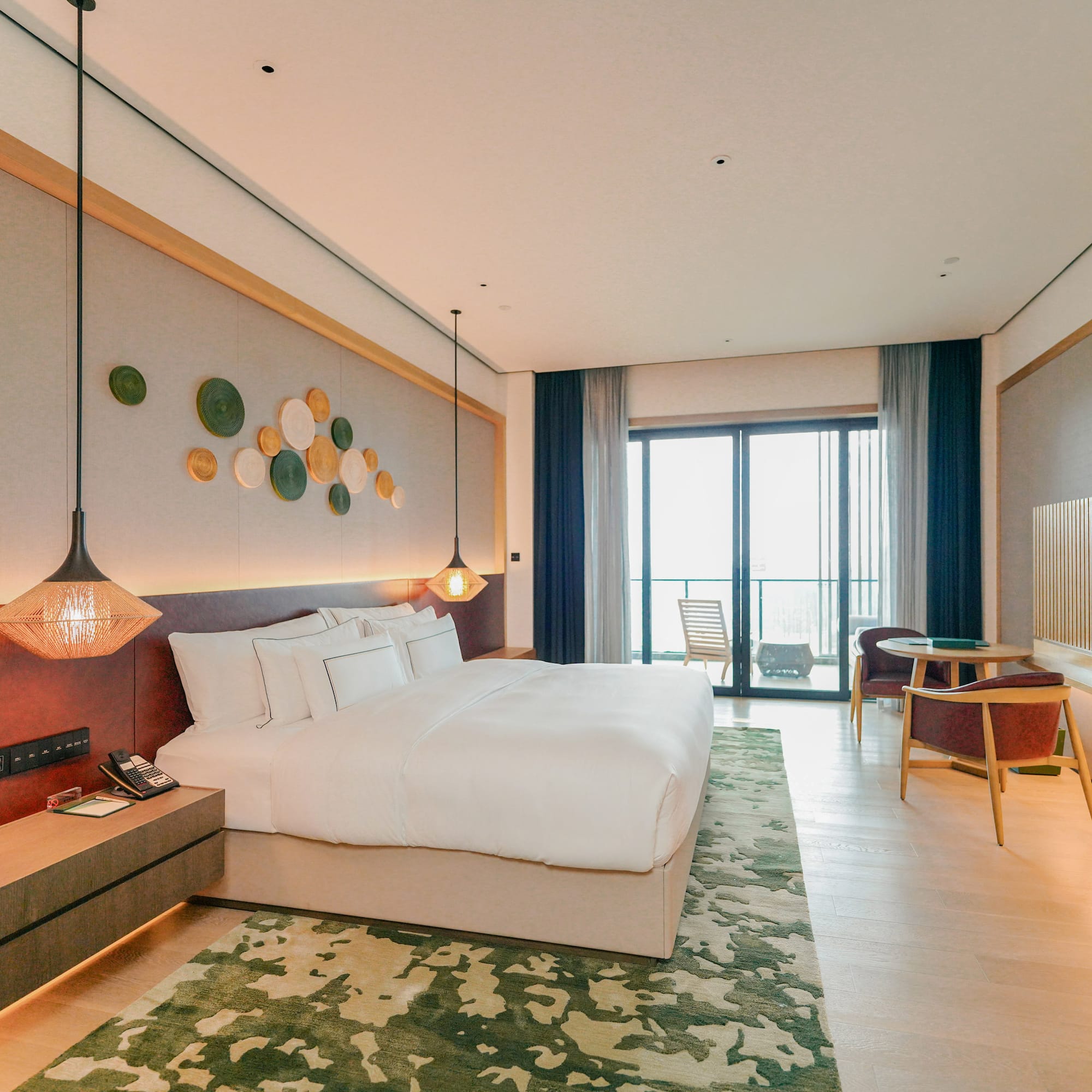 a room with a bed and a table and chairs