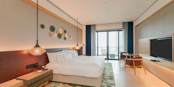 a room with a bed and a table and chairs