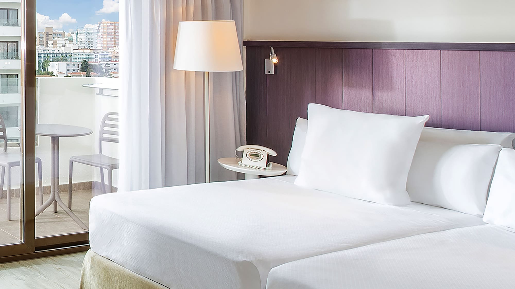 a hotel room with a glass door