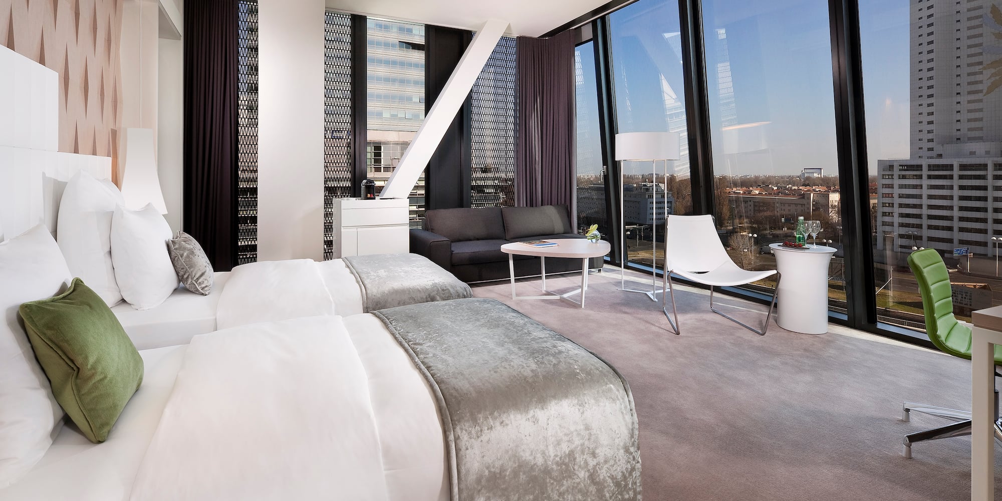 a room with two beds and a couch