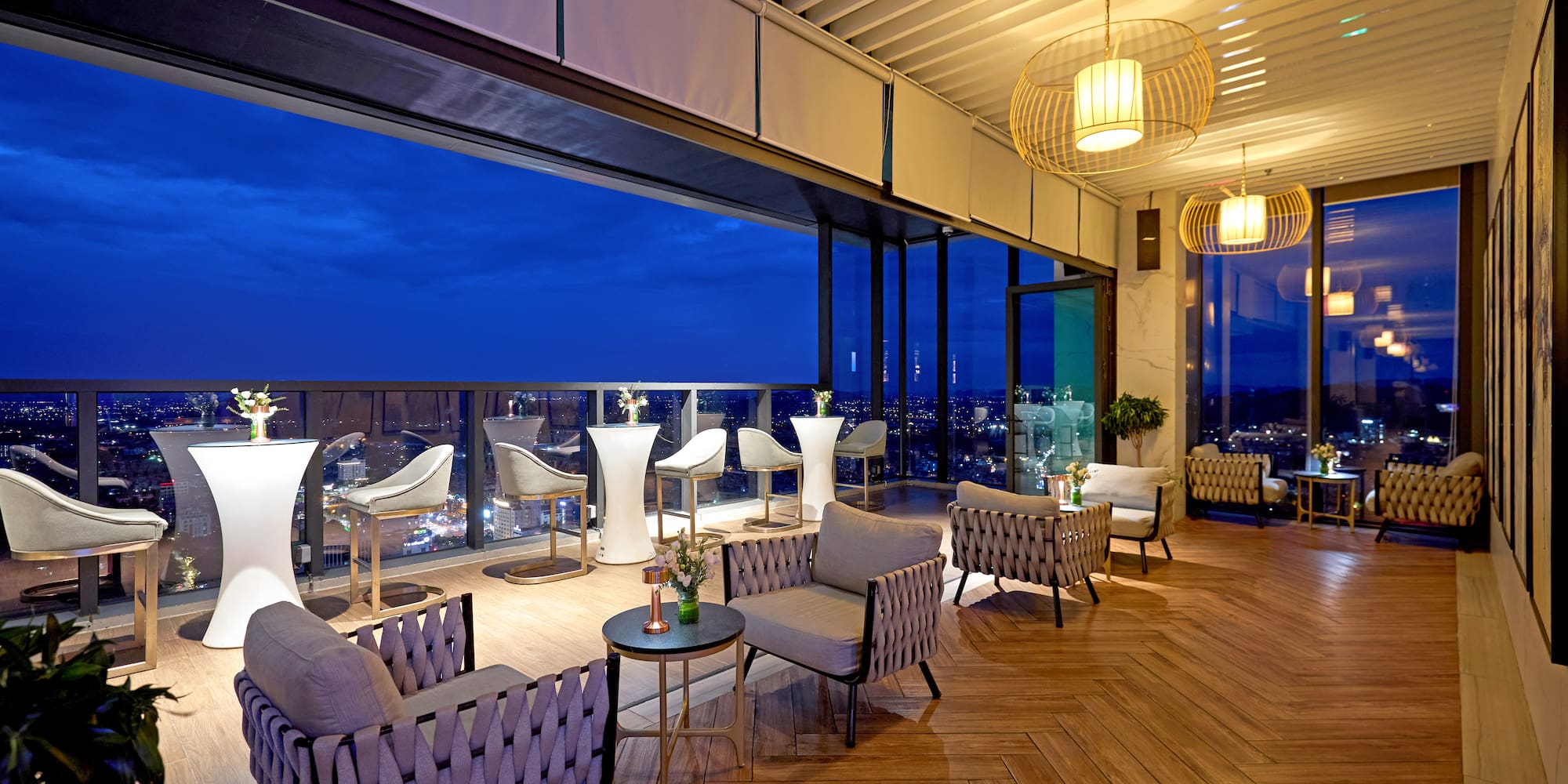 a room with chairs and tables and a view of the city