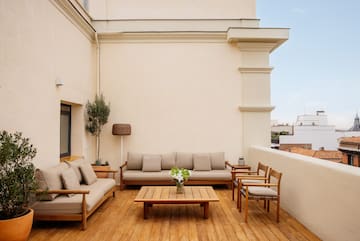 a patio with a table and chairs