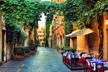 a street with tables and chairs and trees