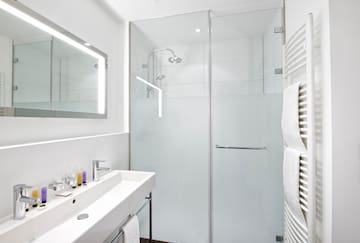 a bathroom with a glass shower and sink
