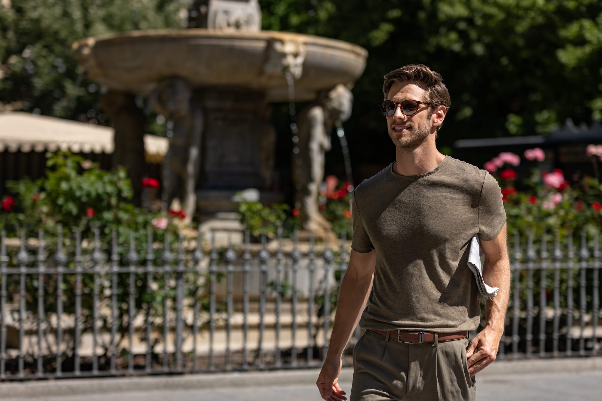 a man walking in front of a fountain
