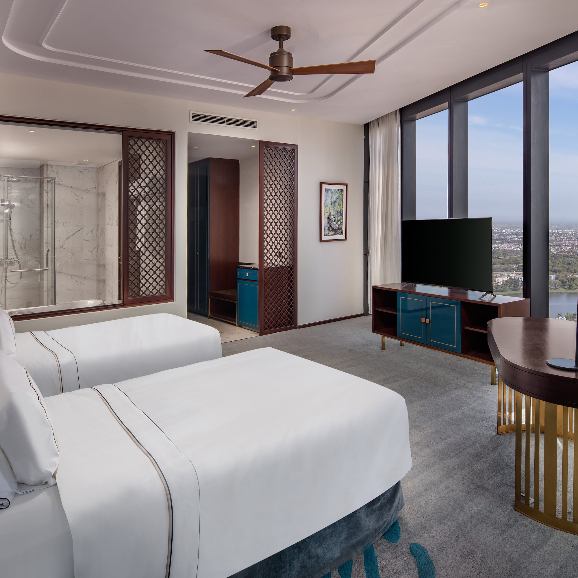 a room with two beds and a television