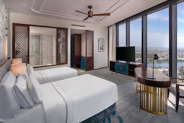 a room with two beds and a television