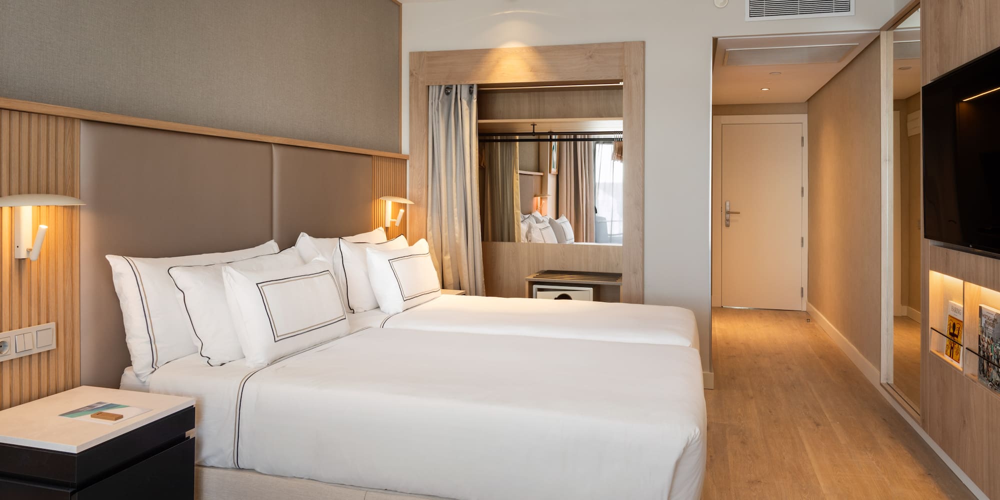 a room with two beds and a ceiling fan