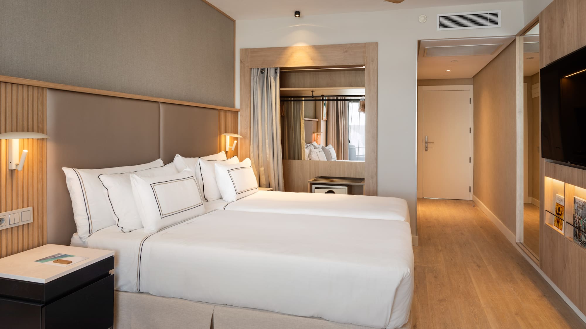 a room with two beds and a ceiling fan