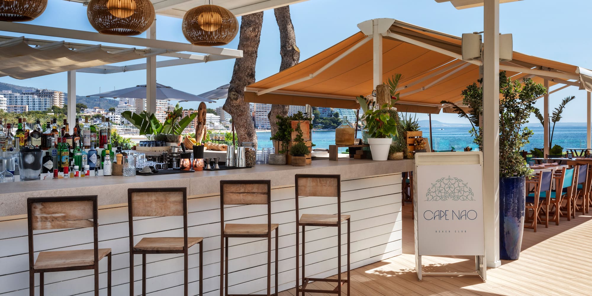 a bar with chairs and a umbrella
