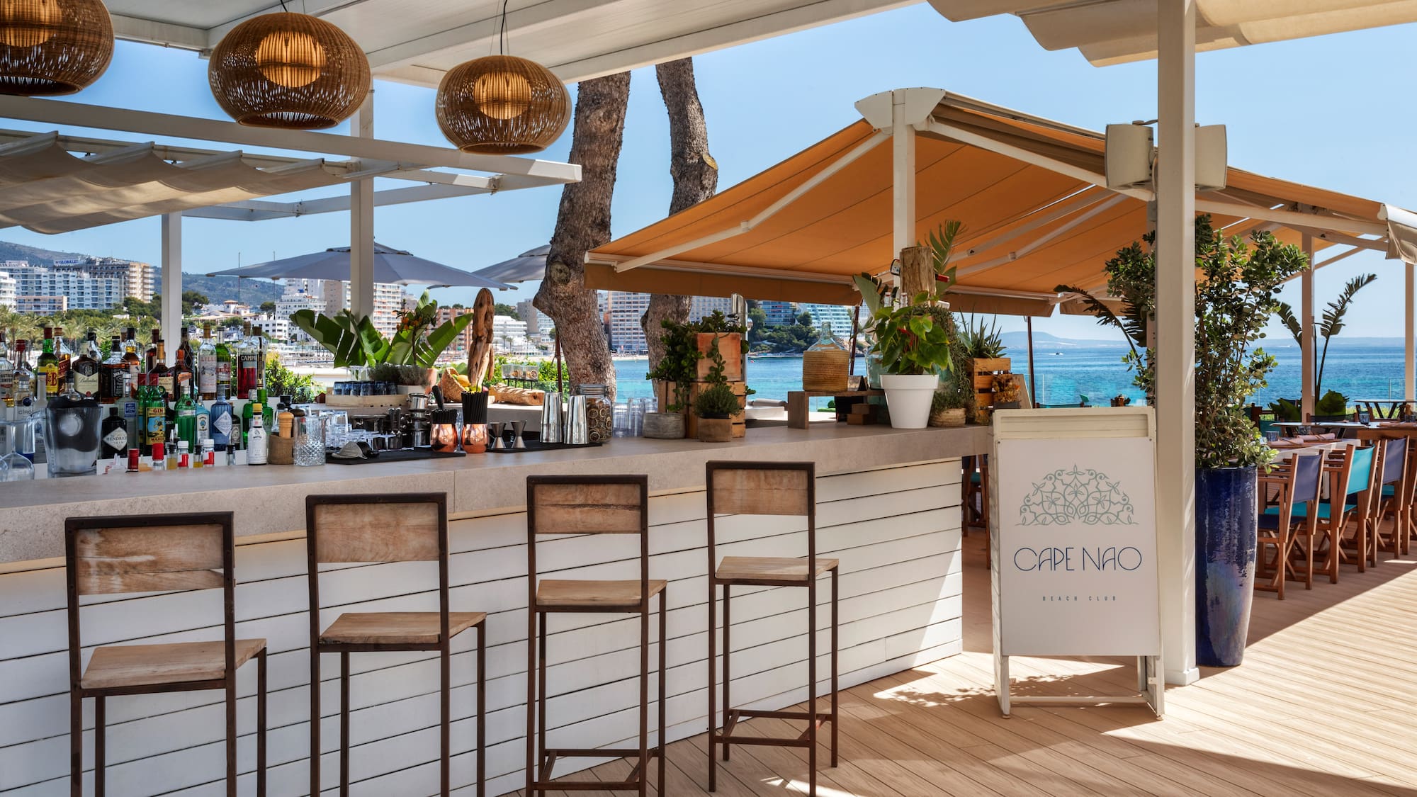 a bar with chairs and a umbrella