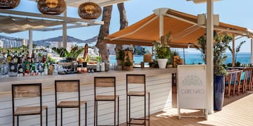 a bar with chairs and a umbrella