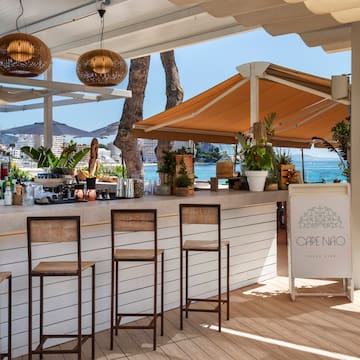 a bar with chairs and a umbrella