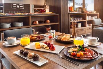 a table with plates of food and drinks