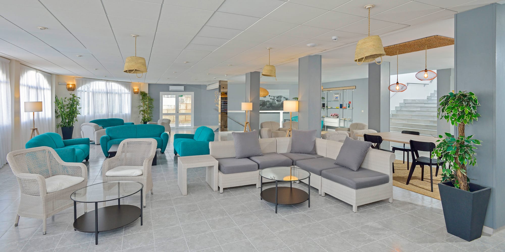 a room with a couch and chairs