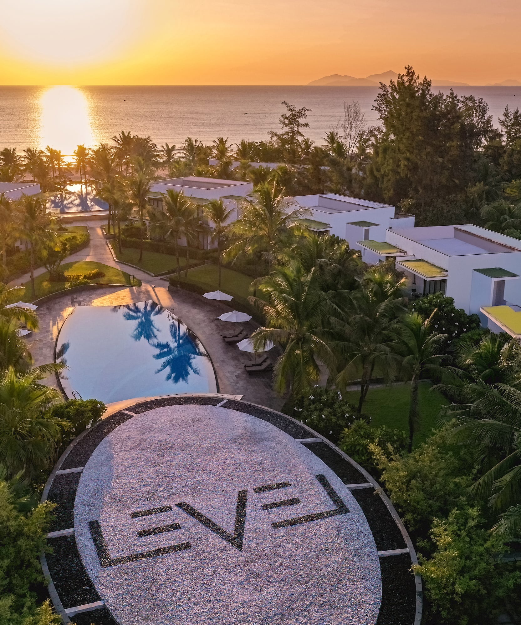 a pool and buildings with trees around it