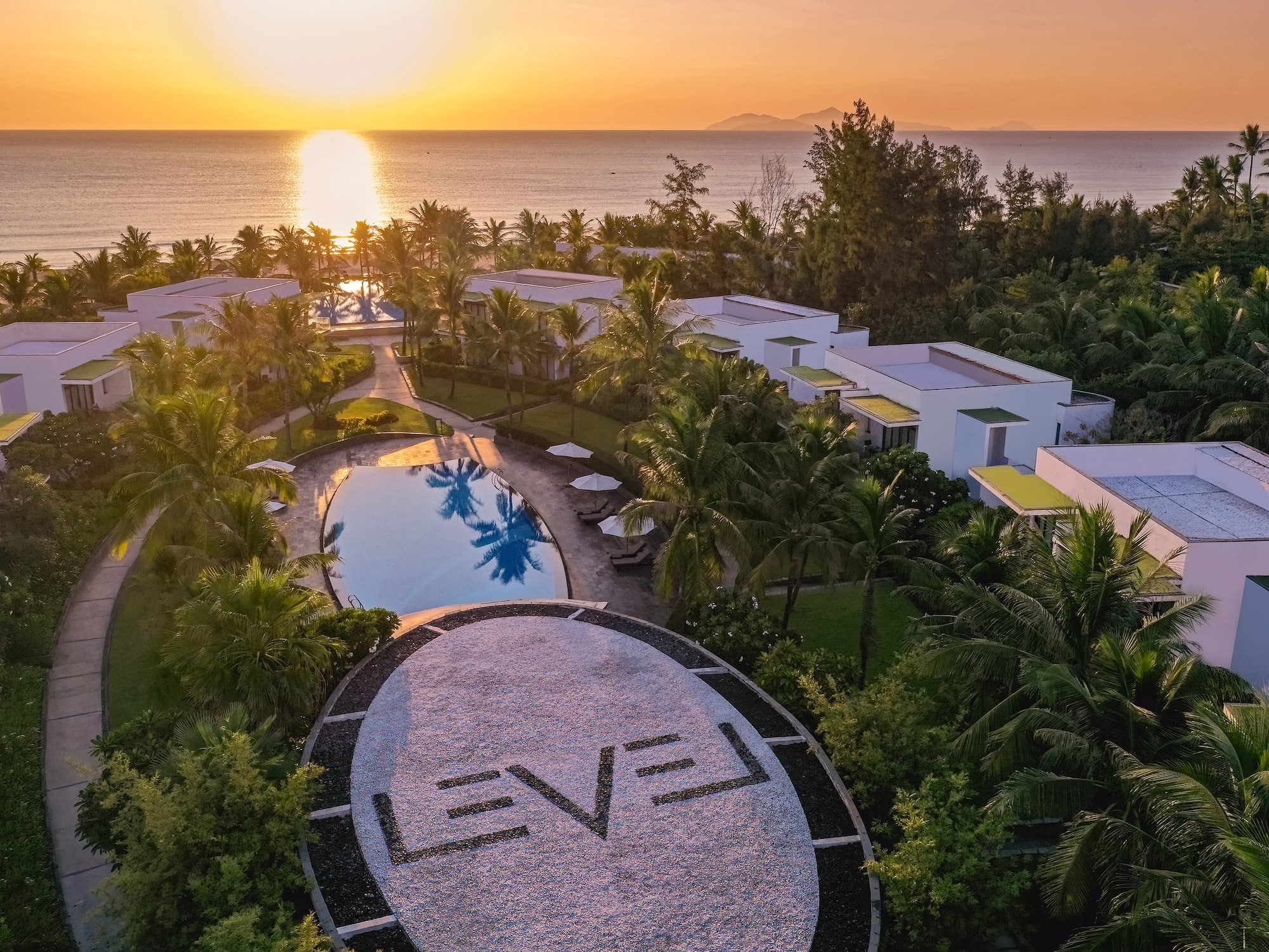 a pool and buildings with trees around it