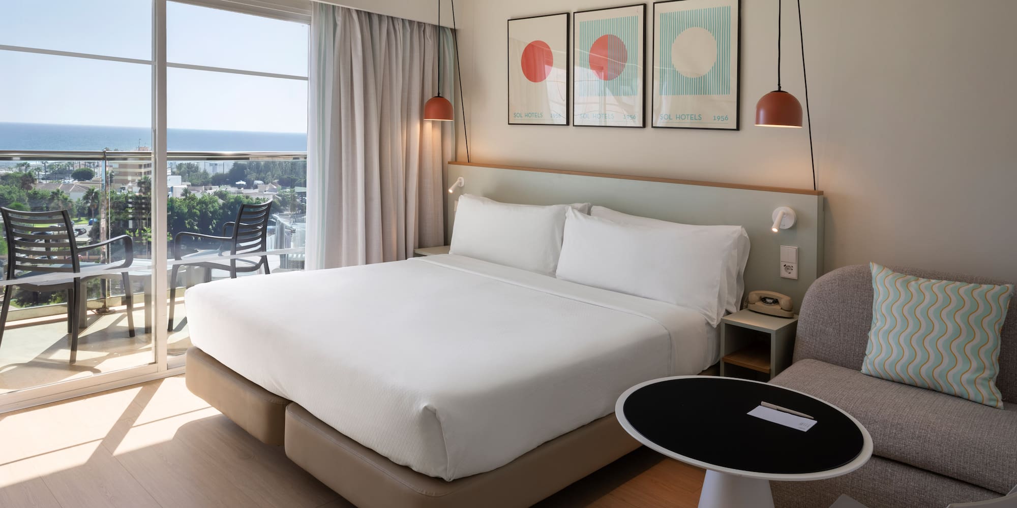 a bed in a room with a table and chairs