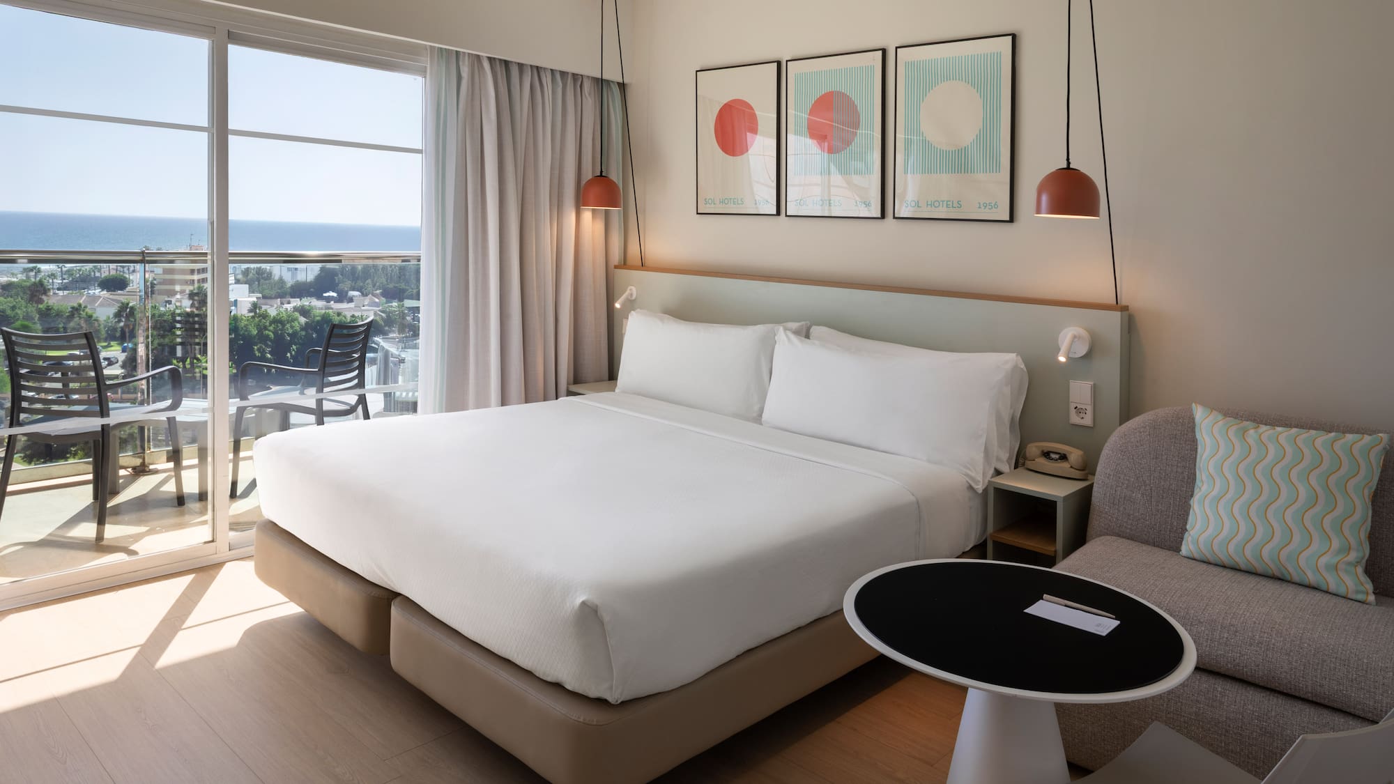 a bed in a room with a table and chairs