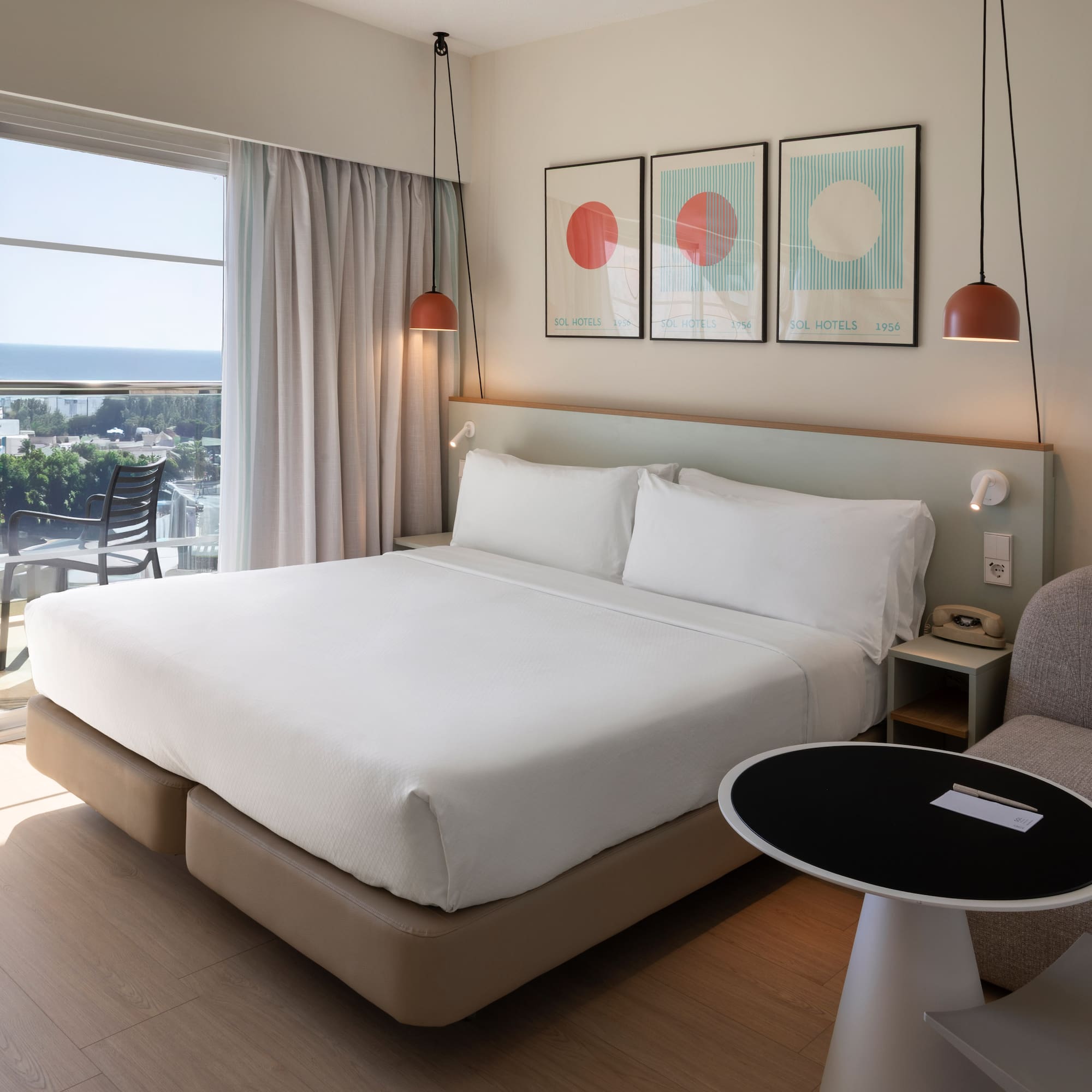 a bed in a room with a table and chairs