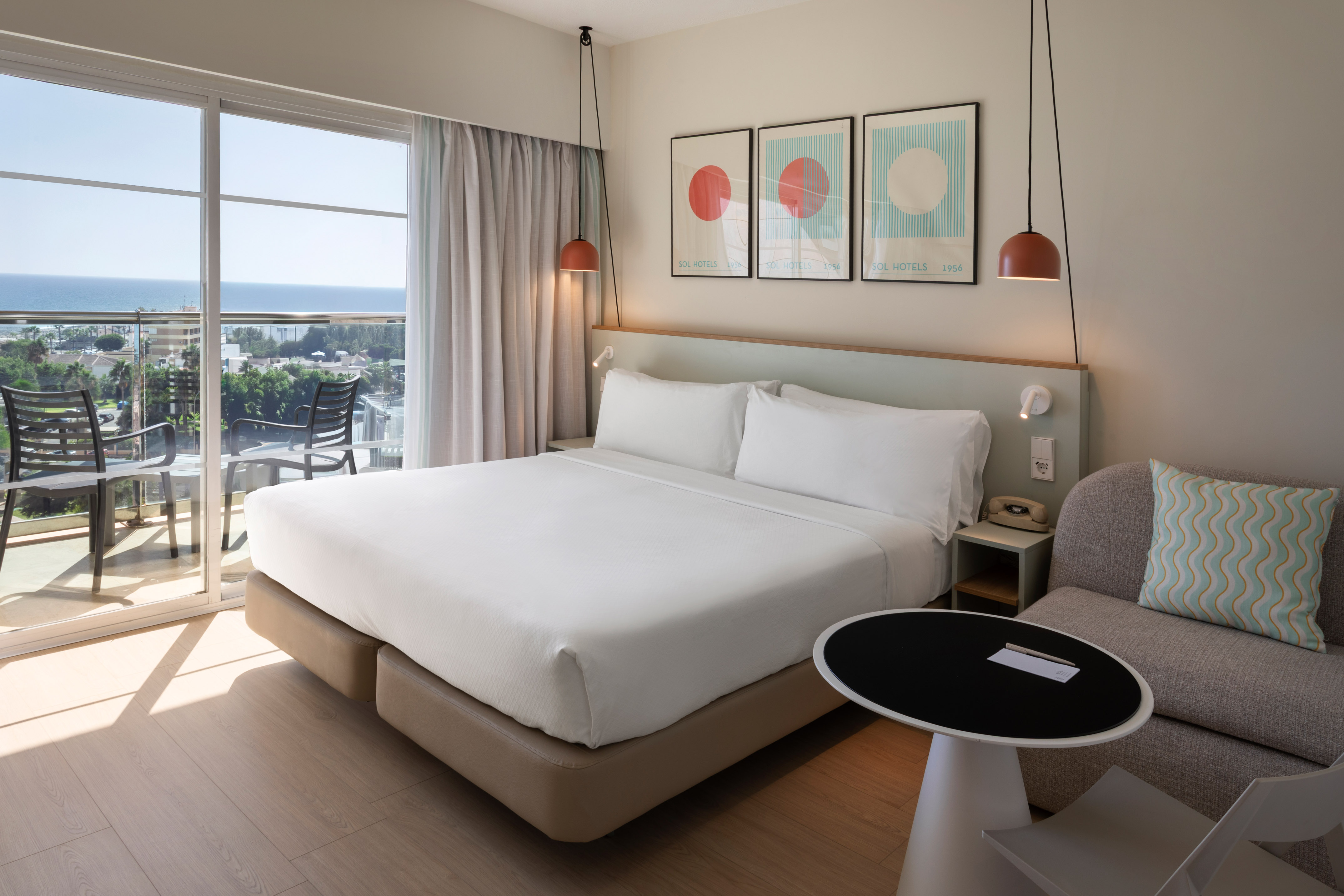 a bed in a room with a table and chairs