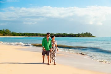 a man and woman walking on a beach