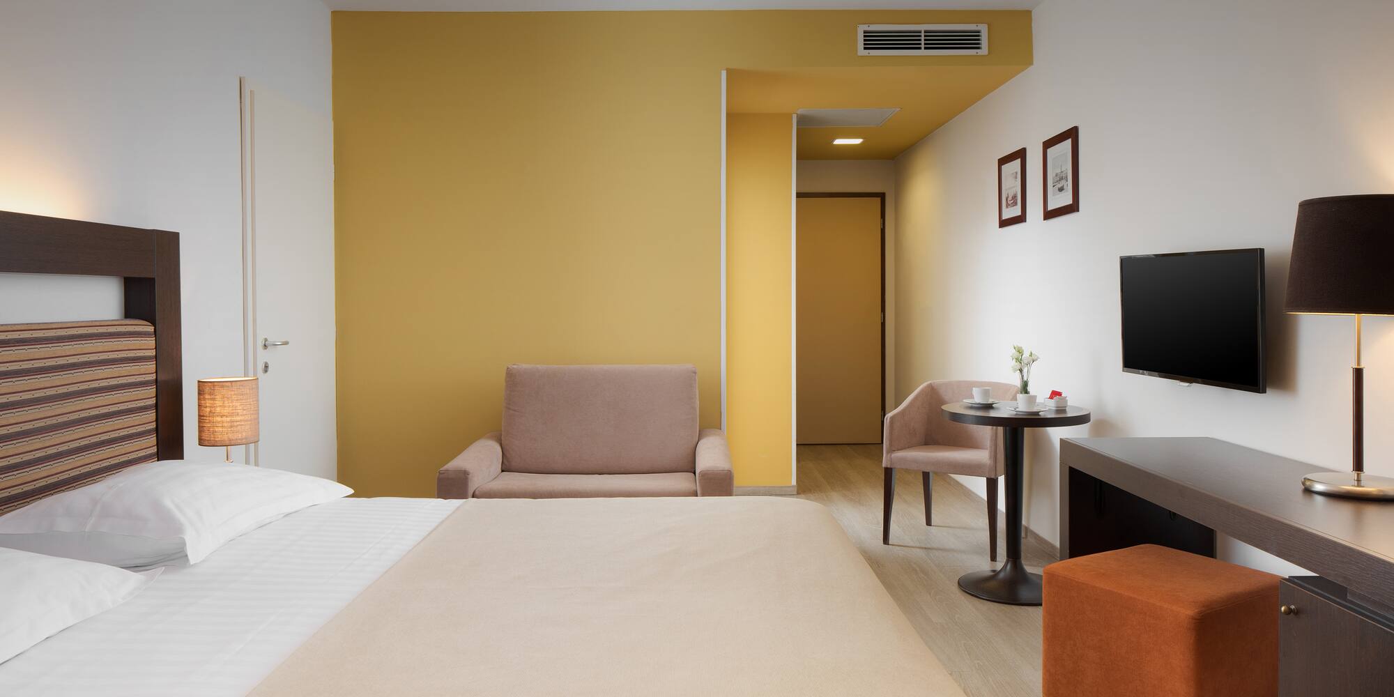 a room with a bed and a television