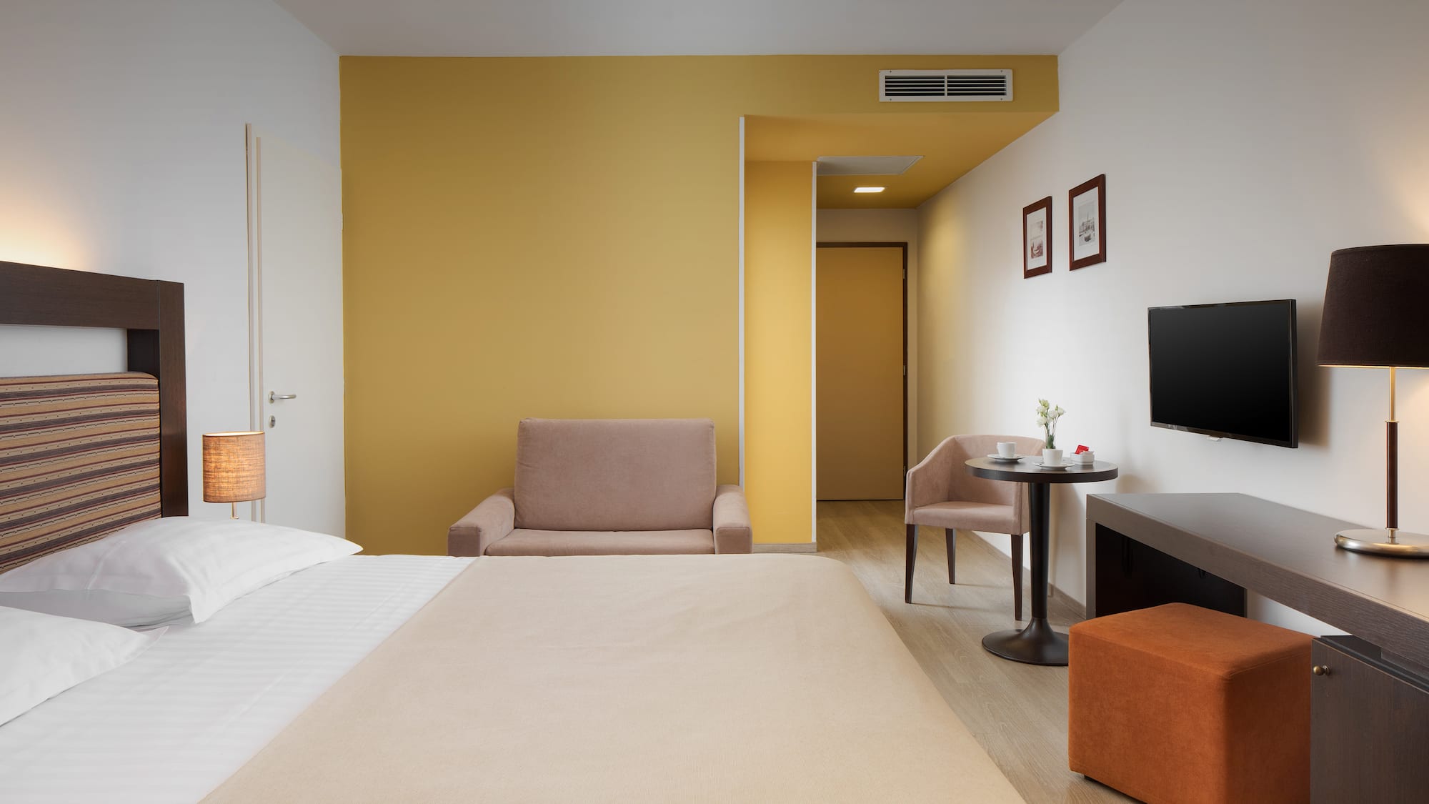 a room with a bed and a television