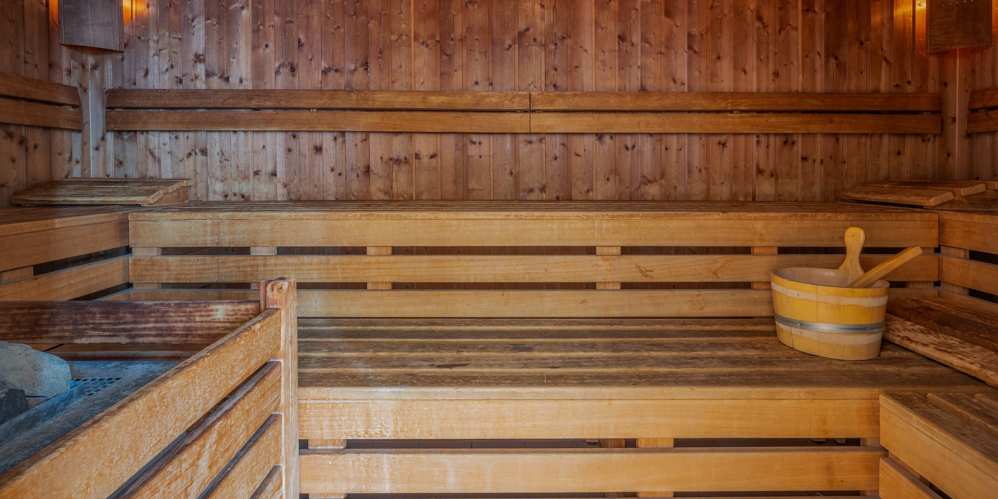 a wooden sauna with a bucket and a bucket