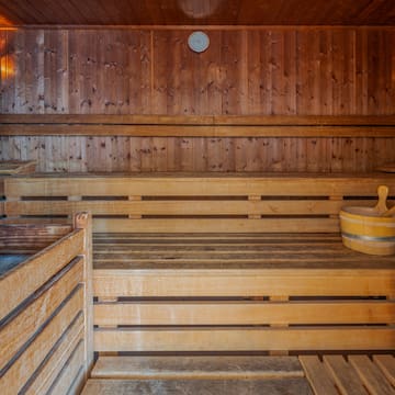 a wooden sauna with a bucket and a bucket