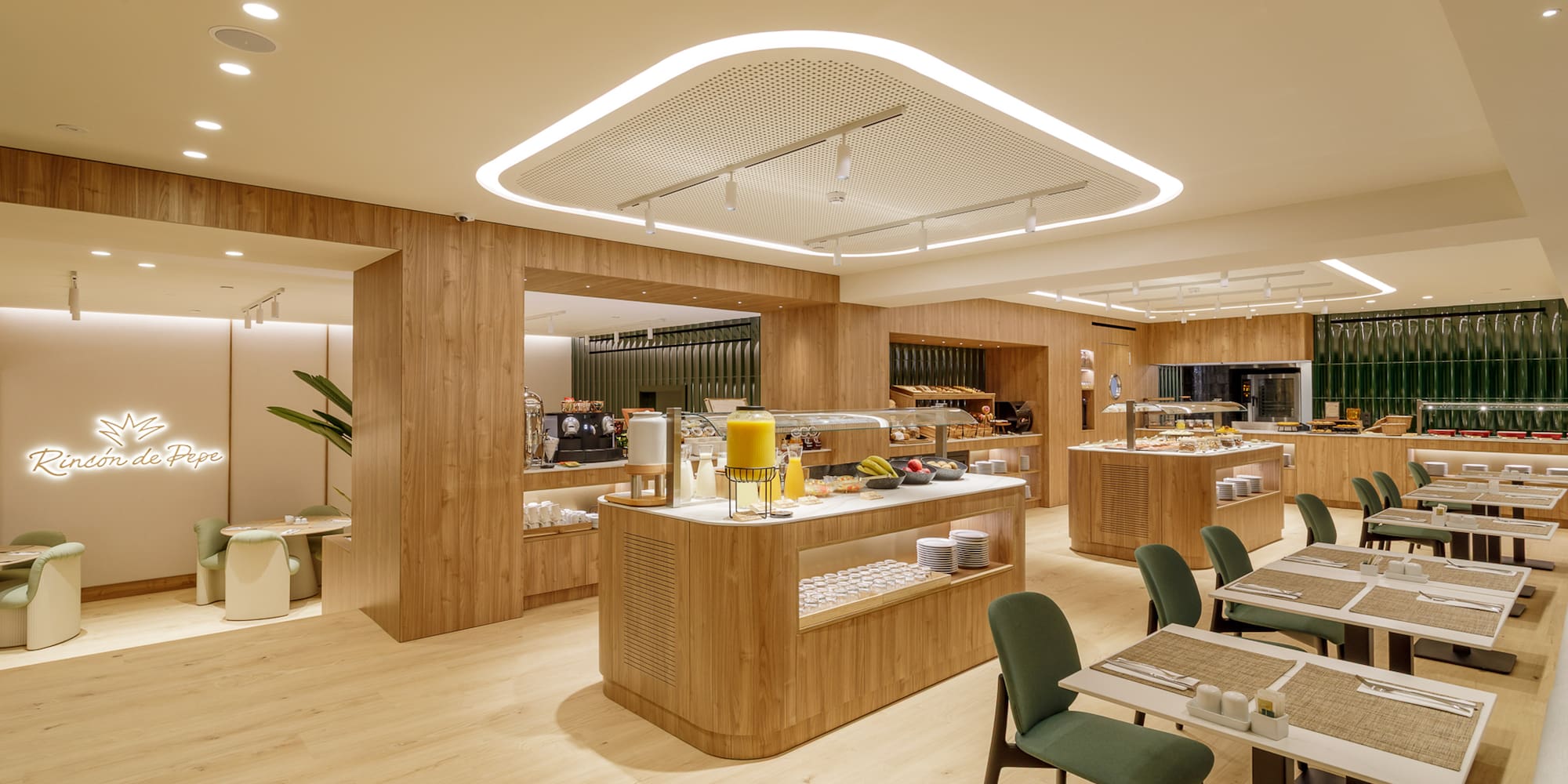 Modern hotel restaurant buffet with wood paneling and green dining chairs.