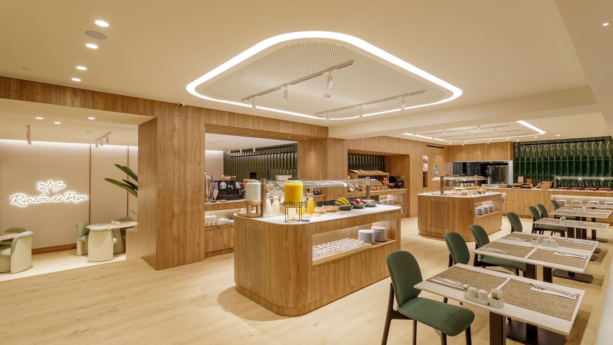 Modern hotel restaurant buffet with wood paneling and green dining chairs.