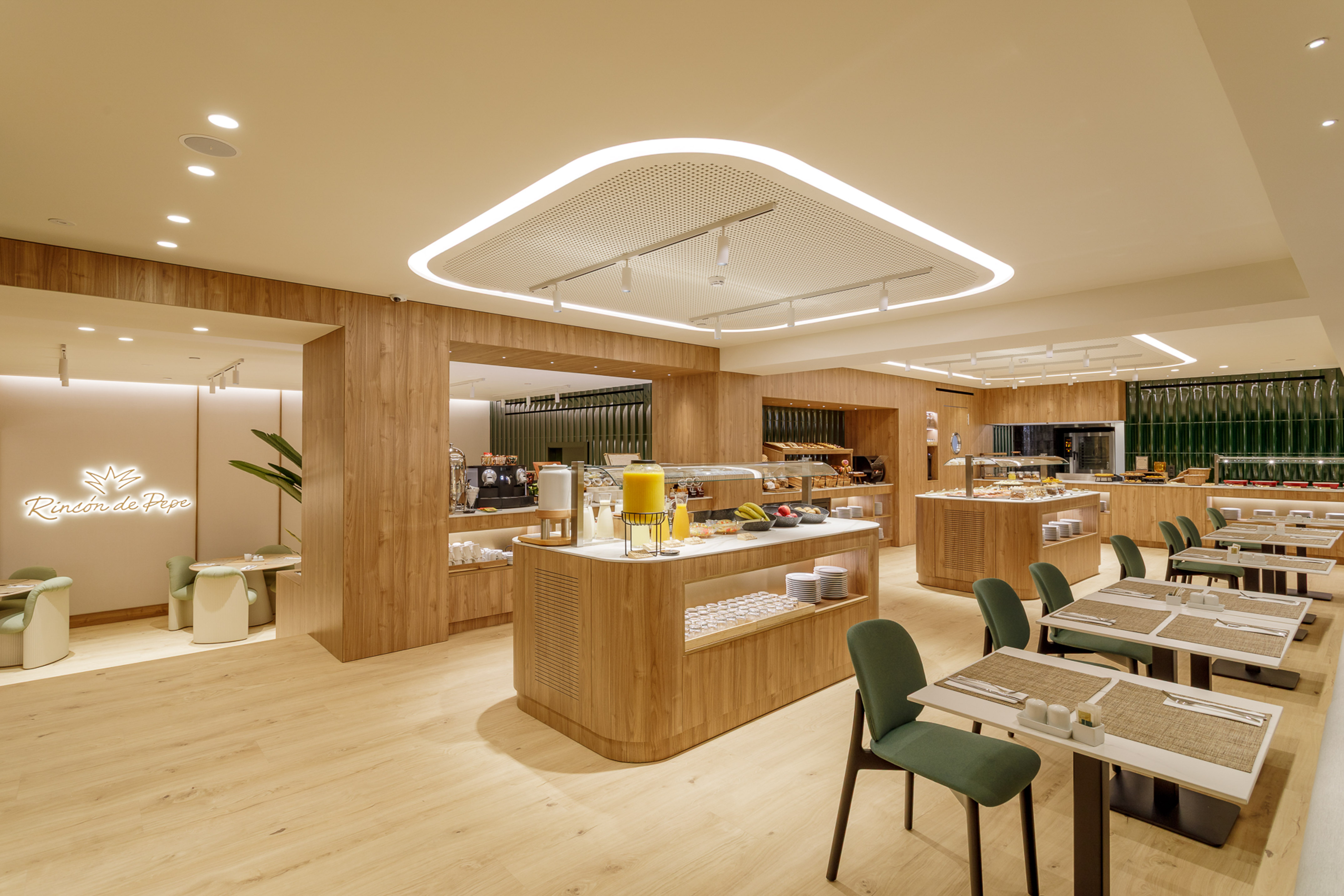 Modern hotel restaurant buffet with wood paneling and green dining chairs.