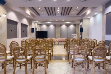 a room with chairs and a television