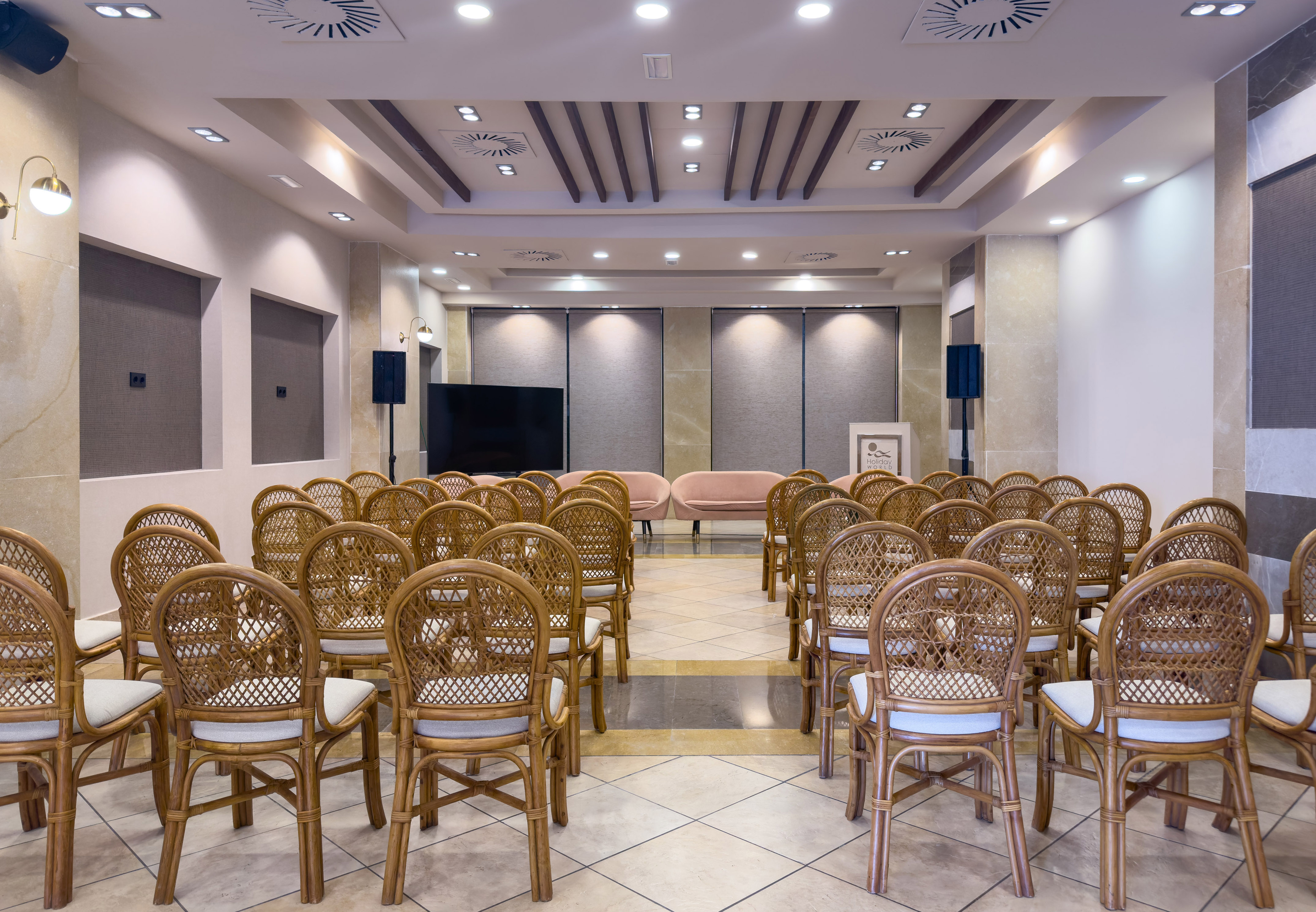 a room with chairs and a television