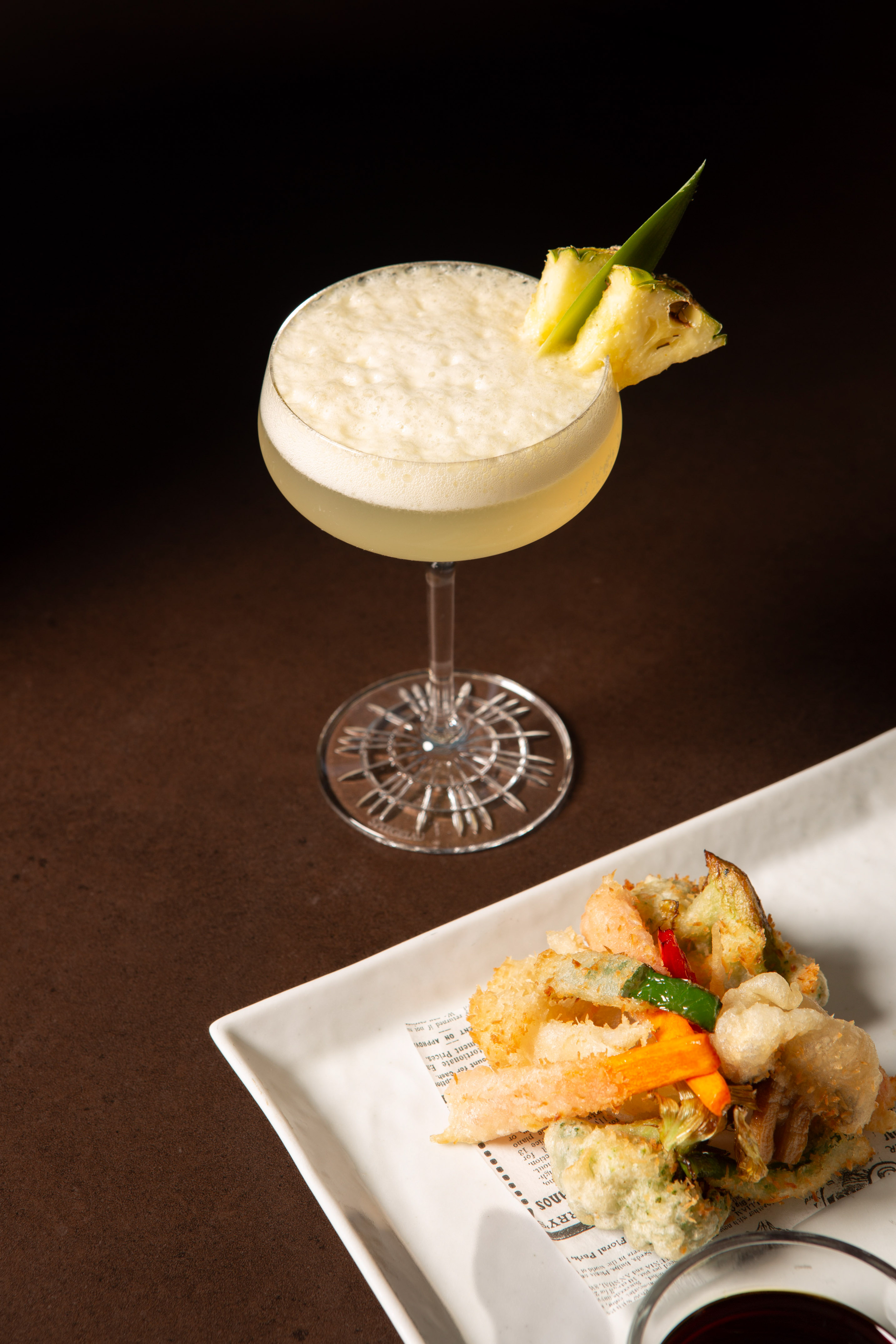 Pineapple cocktail with tempura appetizer and dipping sauce.