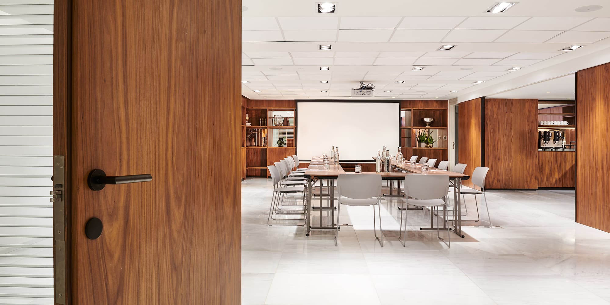 a door open to a room with a table and chairs