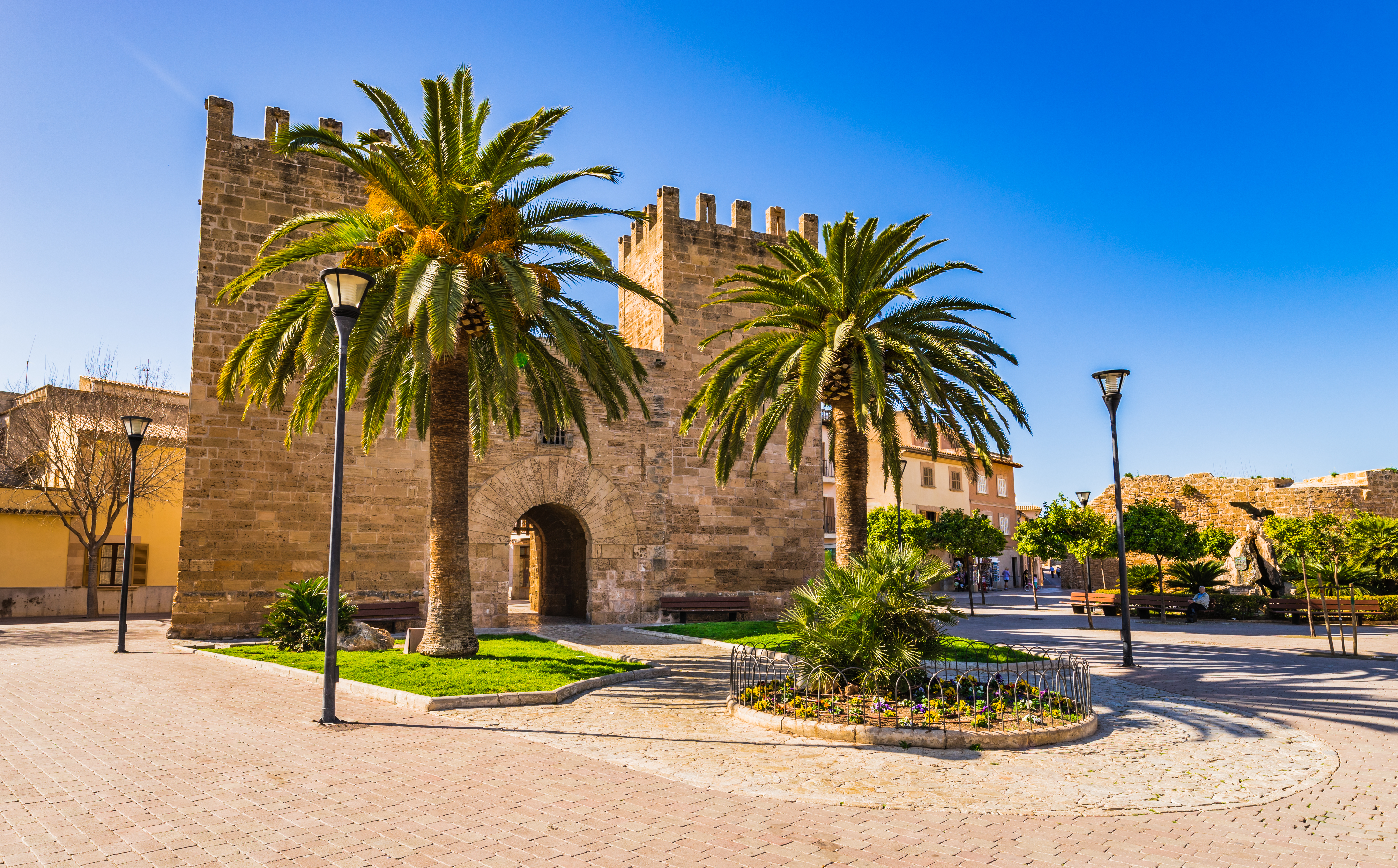 a stone building with palm trees