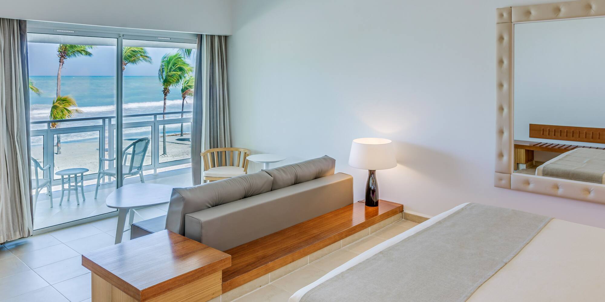 a room with a bed and a table and chairs and a table and chairs