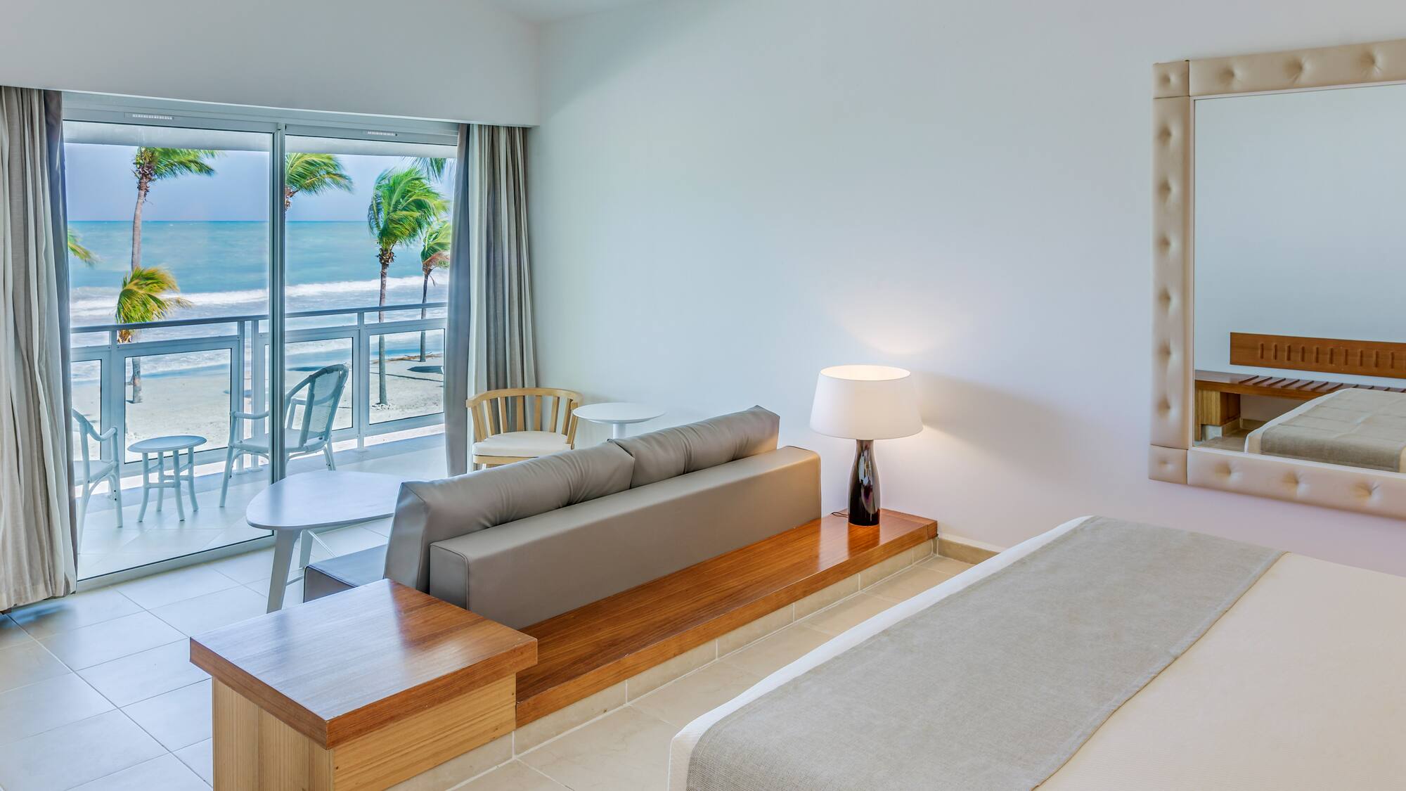 a room with a bed and a table and chairs and a table and chairs