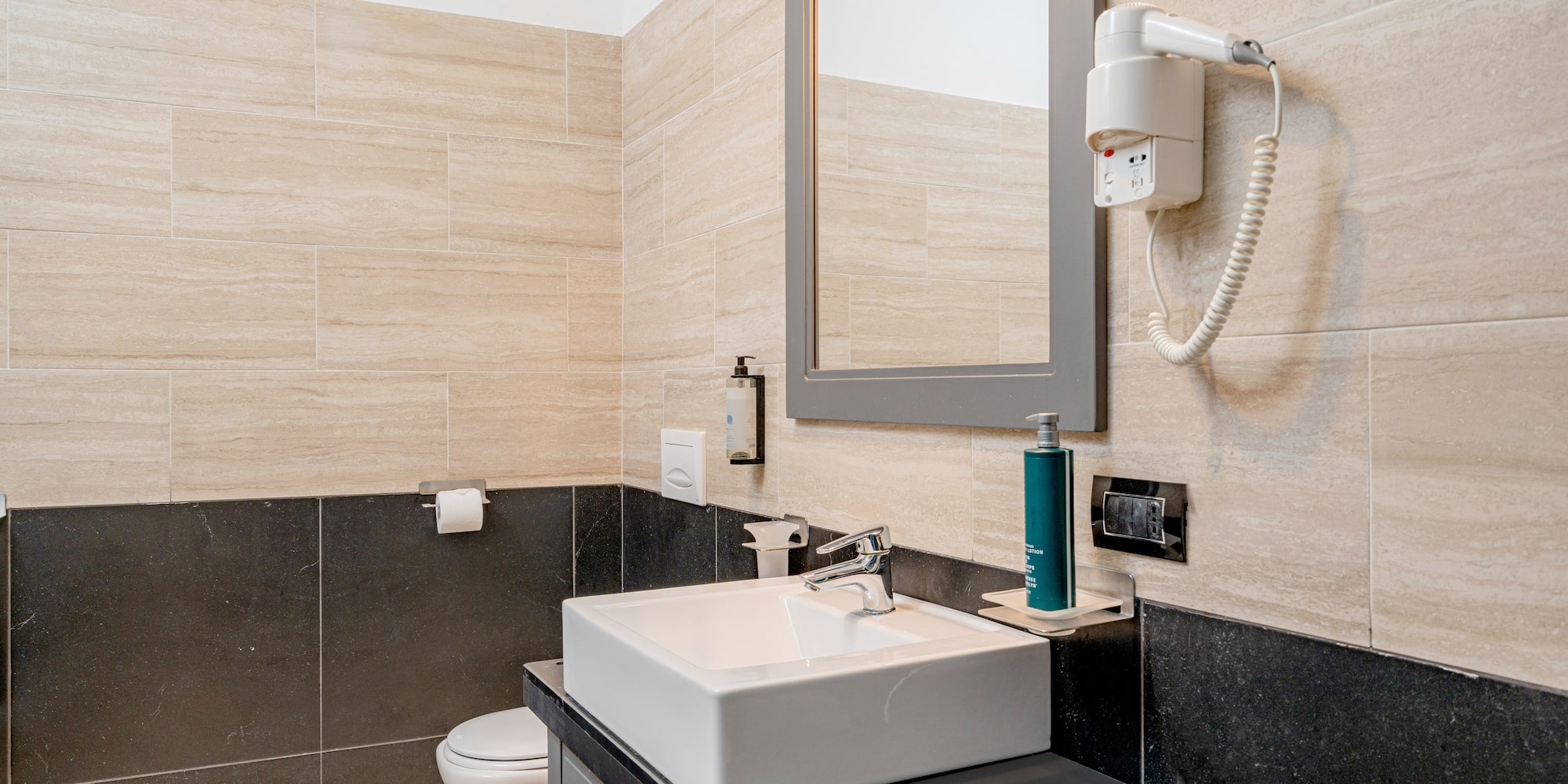 a bathroom with a mirror and sink
