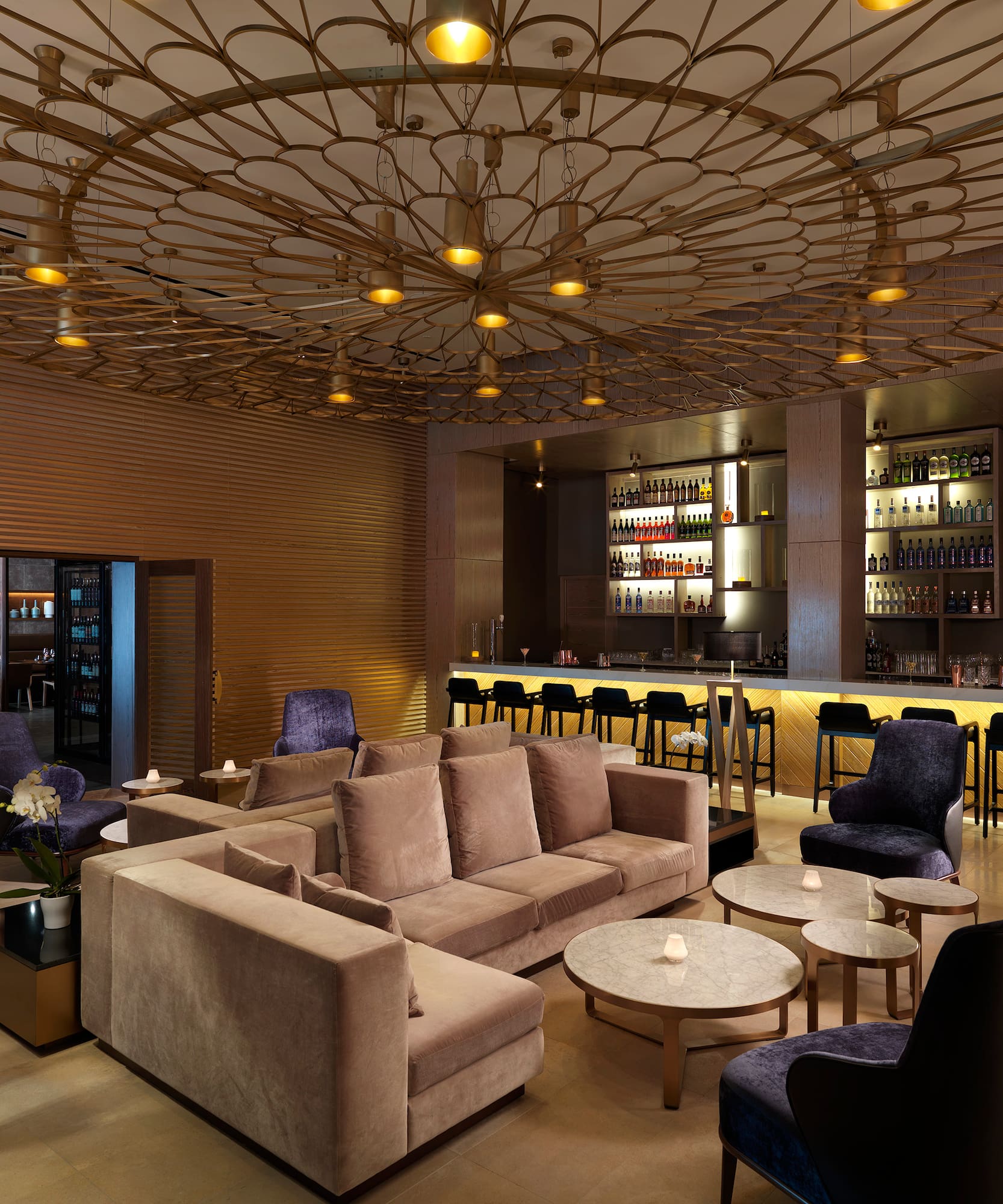 a room with a bar and a couch and tables