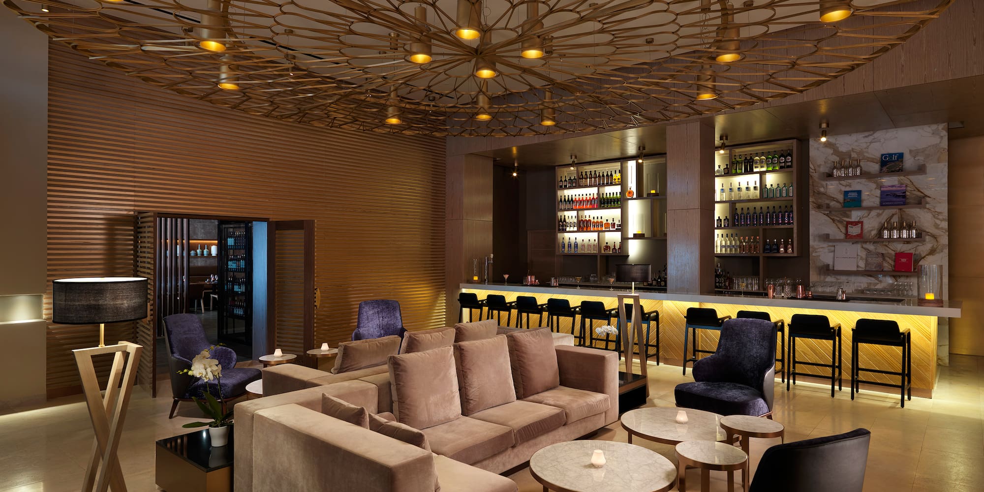 a room with a bar and a couch and tables