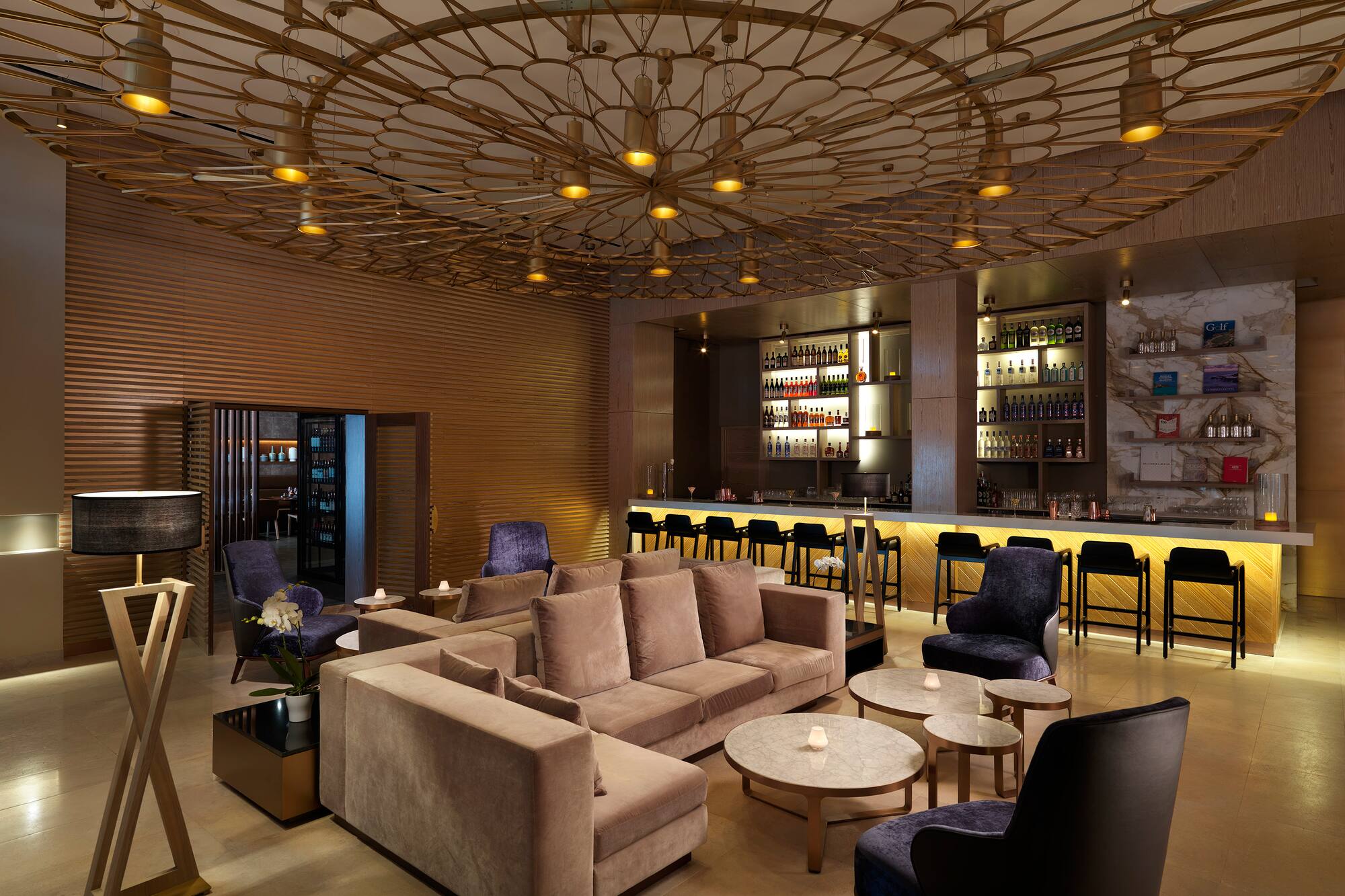 a room with a bar and a couch and tables