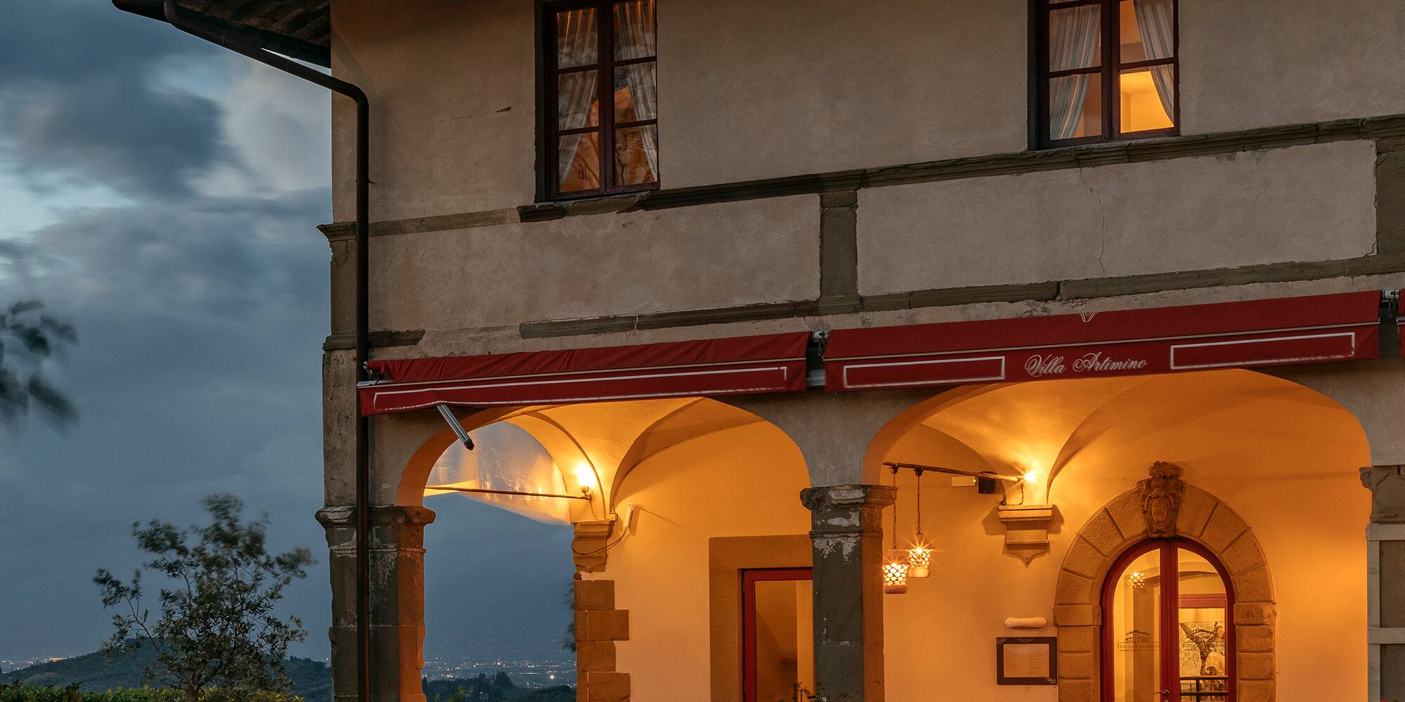 a house with a stone wall and a stone walkway