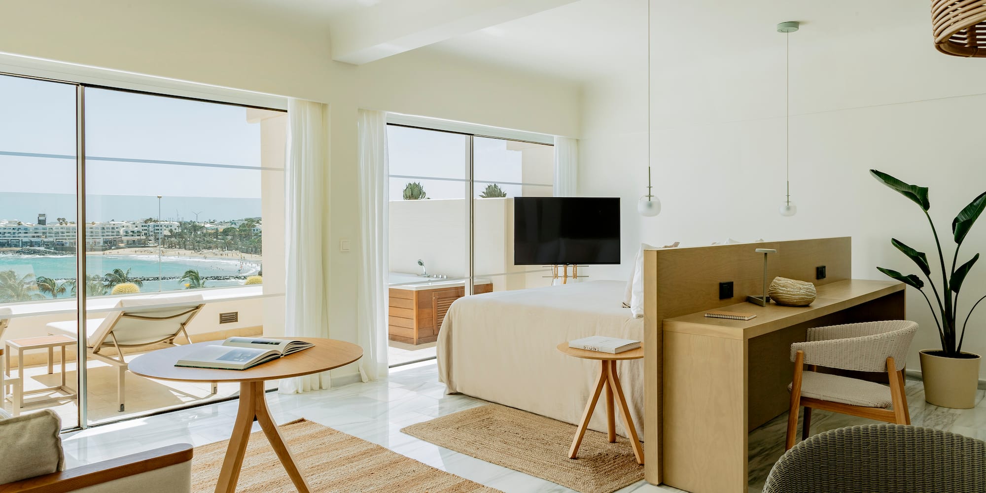 a room with a bed and a table and chairs