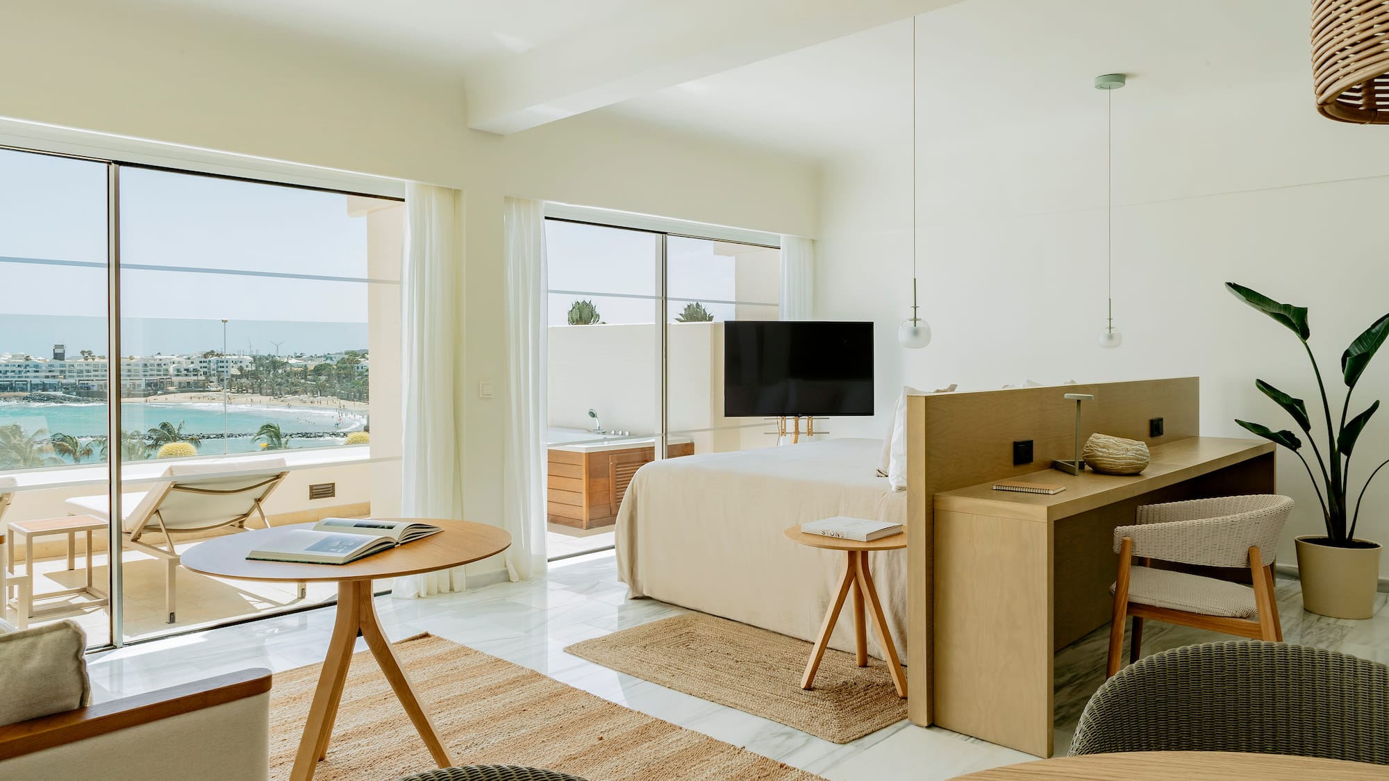 a room with a bed and a table and chairs